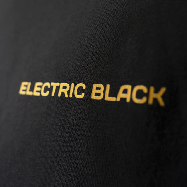 Close-up of the black Electric Black t-shirt with a yellow logo.